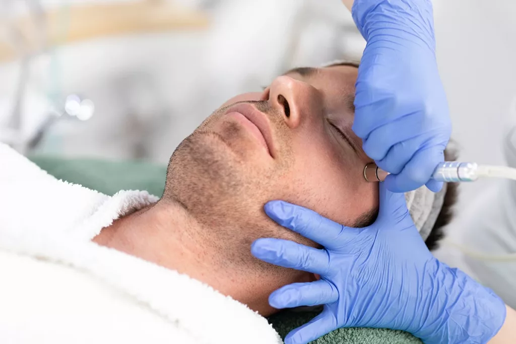 A man getting a DiamondGlow facial rejuvenation treatment at a med spa